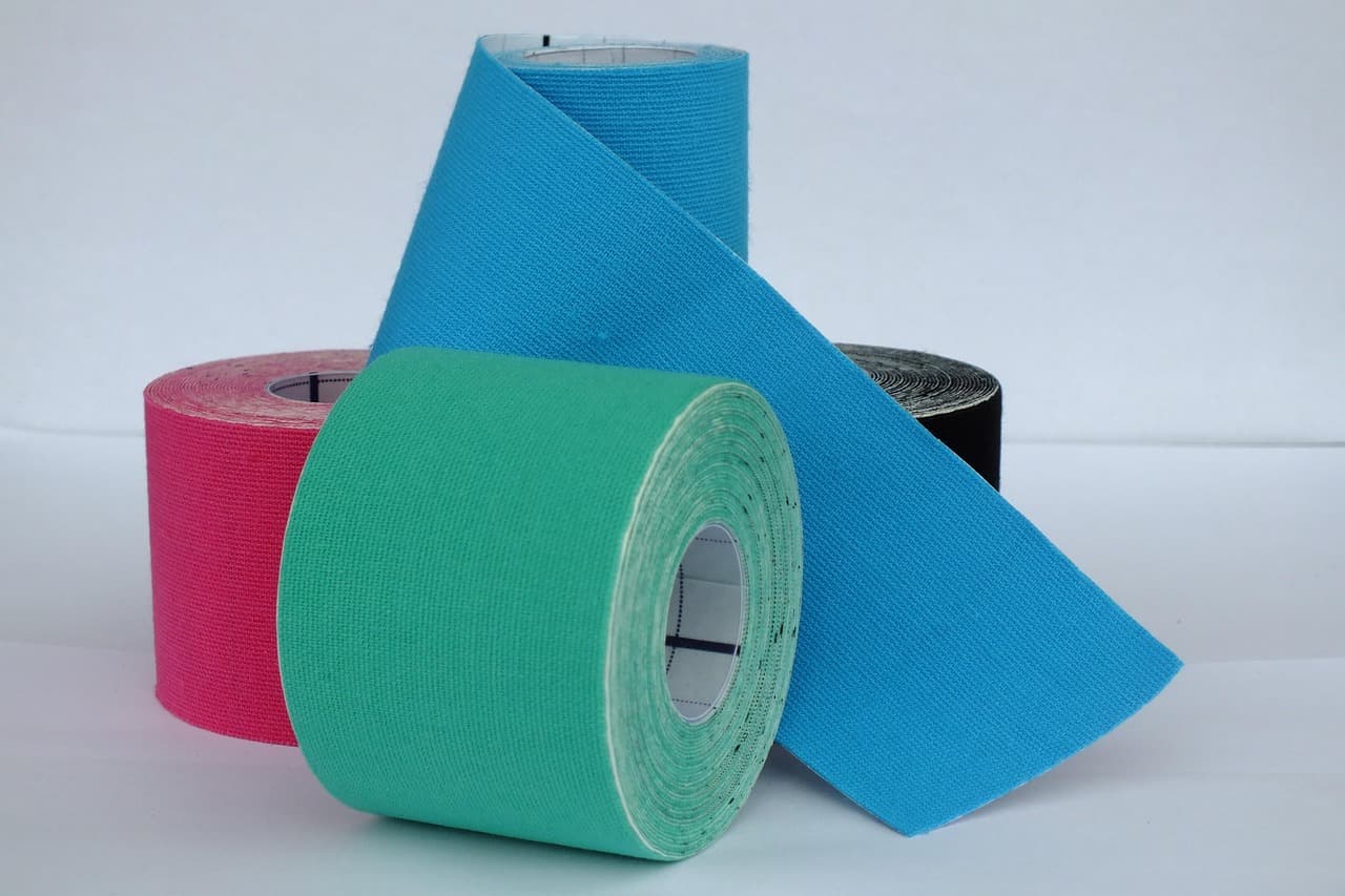 Rolls of kinesiology tape in blue, green and pink