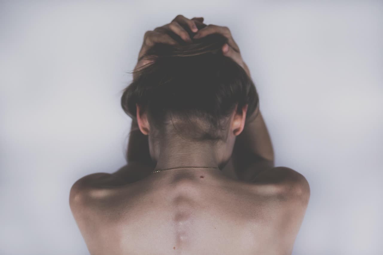 Woman holding the back of her neck